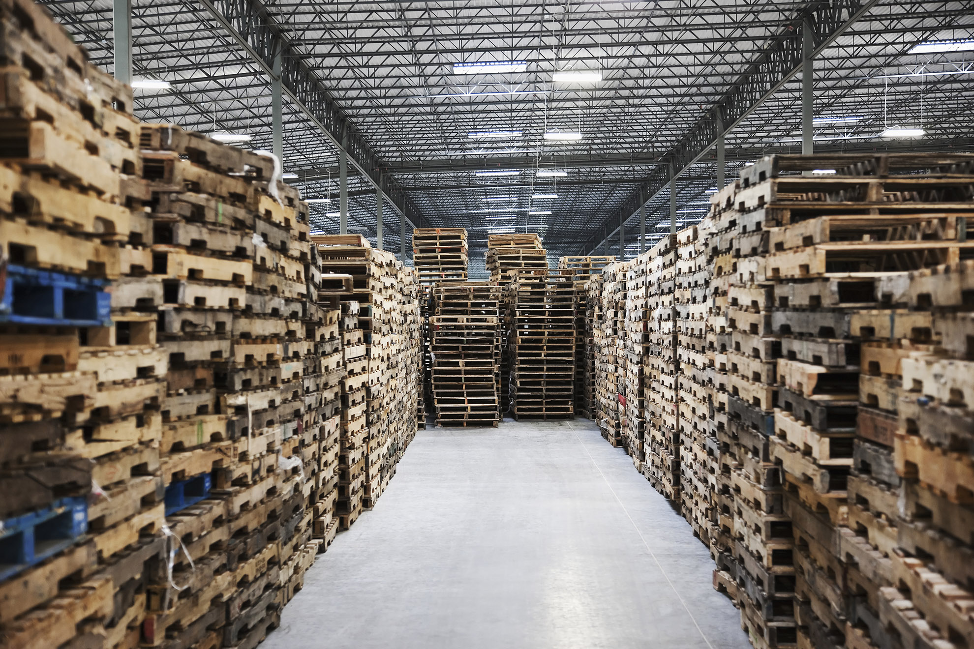 Stacked pallets in warehouse.